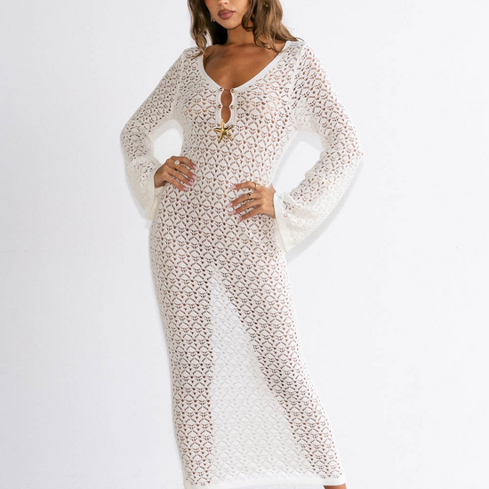 Woman wearing a long, patterned dress against a white background