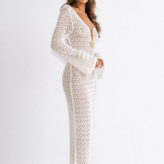 Woman wearing a white lace dress against a white background