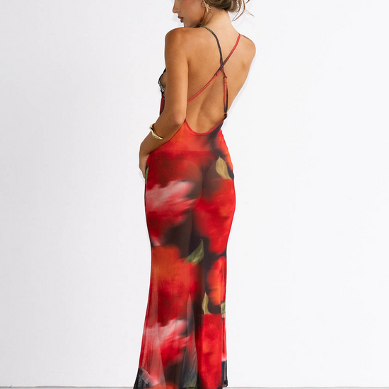 Woman wearing a red floral dress with a white background