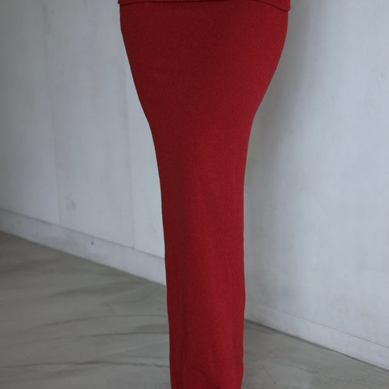 Red skirt worn by a person on a plain background